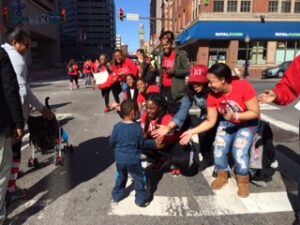 kid high fives red shoe