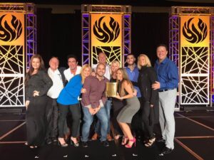 mara-on-stage-with-team