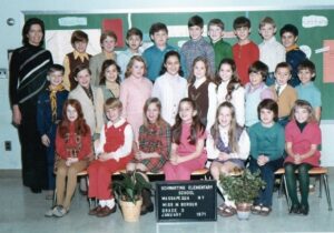 Jamie (Blue sweater vest, second row)